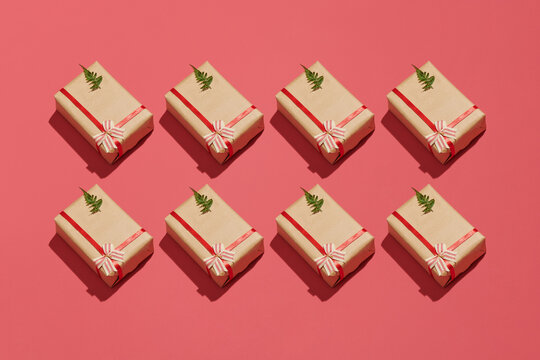 Creative isometric pattern made of gift boxes on red background