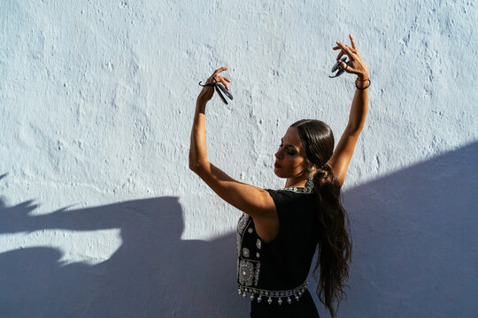 Female Hispanic dancer performing flamenco dance