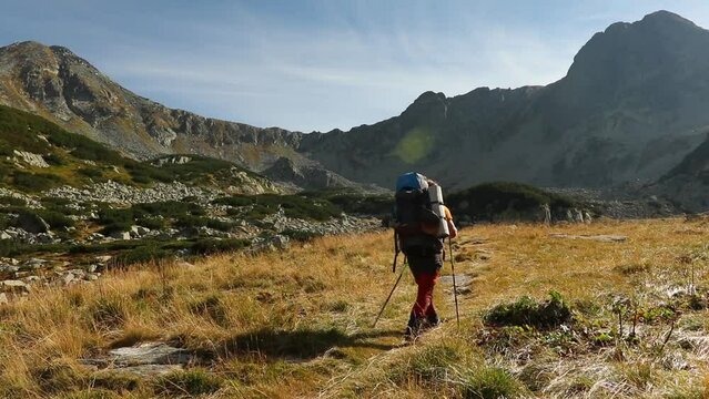 Caucasian backpacker man hiking through valleys of Biosphere Reserve, Romania