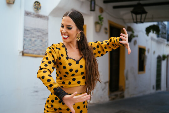 Gitana lady dancing flamenco on town street