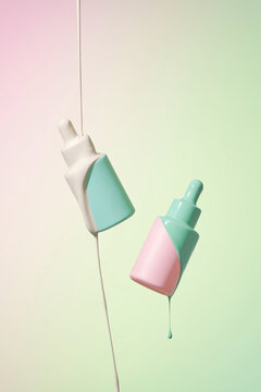 Milk falling on serum bottle on multicolor background