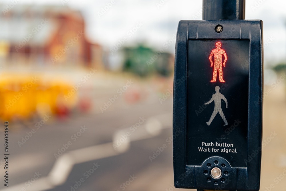 Poster closeup of a pedestrian crossing push button, traffic signal control with a red man symbol