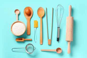 Wooden baking utensils on turquoise background