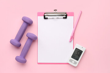 Blank clipboard with glucometer and dumbbells on pink background. Diabetes concept