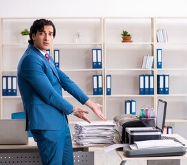 Young employee making copies at copying machine
