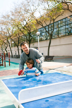father and son playing table tennis