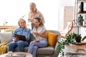 Mature women taking part in book club at home