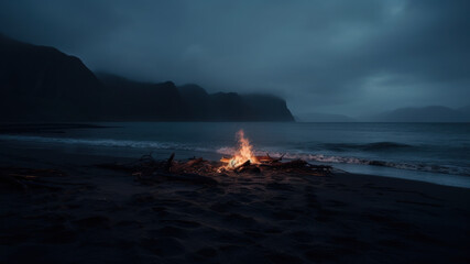 Burning campfire on the lonely overcast beach. Camping on the beach at night. Cloudy, foggy and rainy weather. Moody and dramatic.