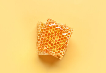 Sweet honeycombs on yellow background