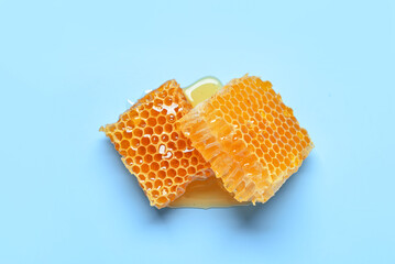 Sweet honeycombs on blue background