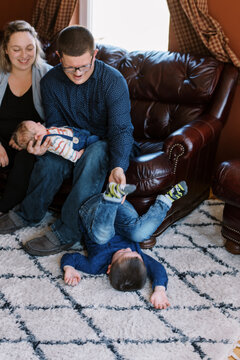 laughing upside down toddler at home being tickled