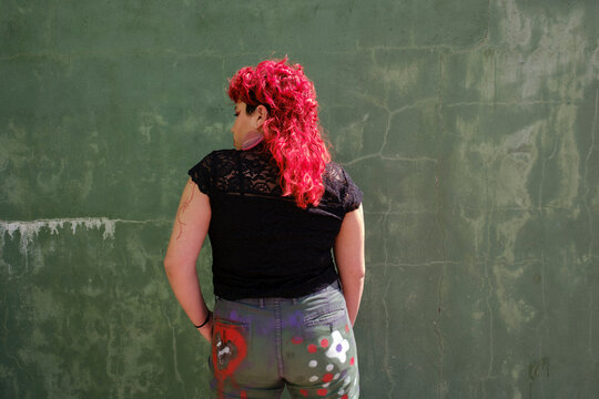 Back of red hair person over green background