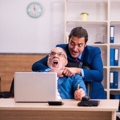 Old male boss and his young male assistant in bullying concept