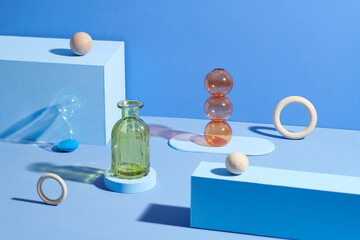 Colorful glass vases with geometric shapes on the podium