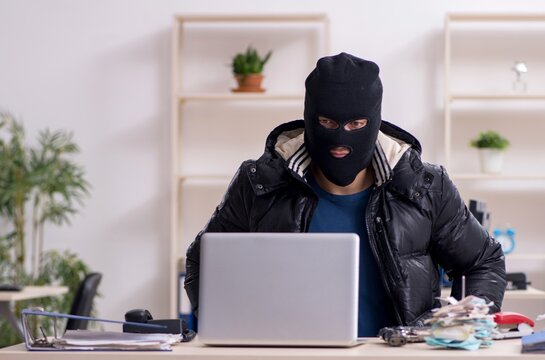 Young male burglar in the office