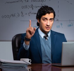Financial specialist working late in the office