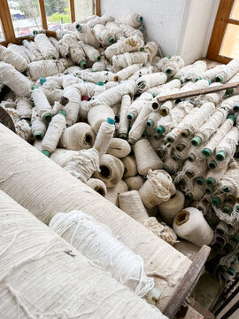 A pile of spool of white wool