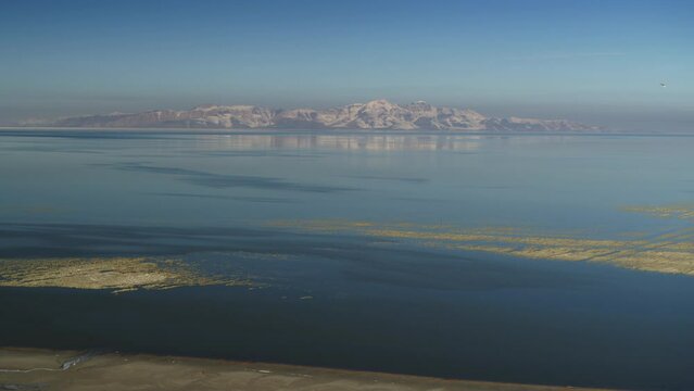 Aerial flyover view of receding water in Great Salt Lake / Magna, Utah, United States