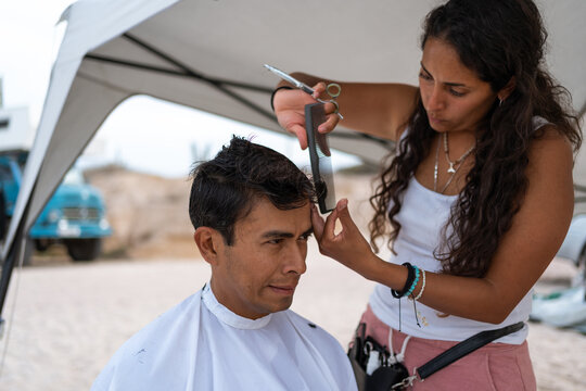 mexican man at barber on the beach