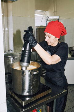 chef holding an immersion blender