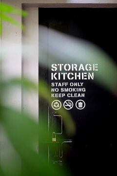 Storage kitchen sign on the black door