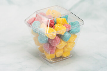 Sweets, beautiful colorful candies and accessories positioned on light surface, selective focus.
