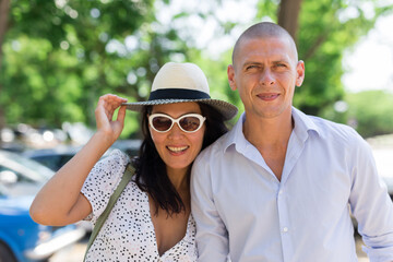 Obraz premium Woman and man holding each other hand and walking in summertime