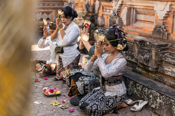 Balinese bride and caucasian groom during multiracial wedding ceremony