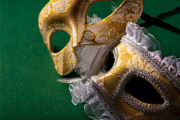 Carnival mask, beautiful carnival mask placed on green felt background, selective focus.
