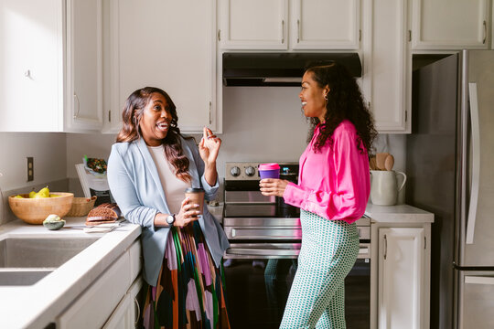 Adult best friend and roommates in kitchen