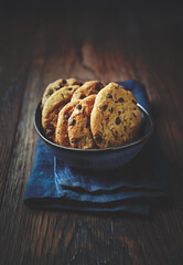 Chocolate chip cookies with hazelnuts in a blue ceramic bowl