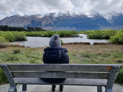 Enjoying the beautiful view of the lake and mountains from a bench