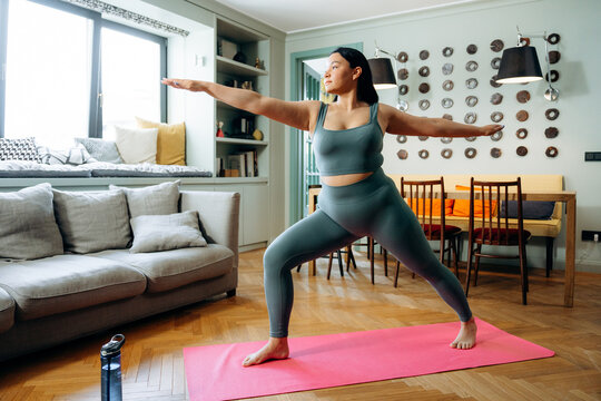A woman does yoga at home