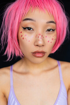 Asian woman with pink hair