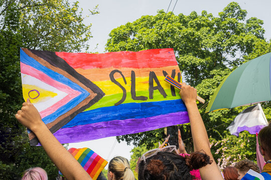 Pride Parade participant with Intersex-Inclusive Progress Pride Flag