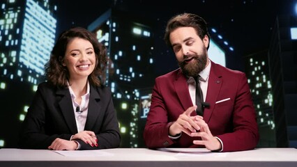 Global tv hosts doing reportage on late night show, discussing about international breaking news in newsroom. Team of presenters creating newscast for entertainment segment program.