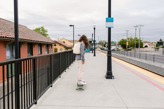 Teenager on skateboard at train station