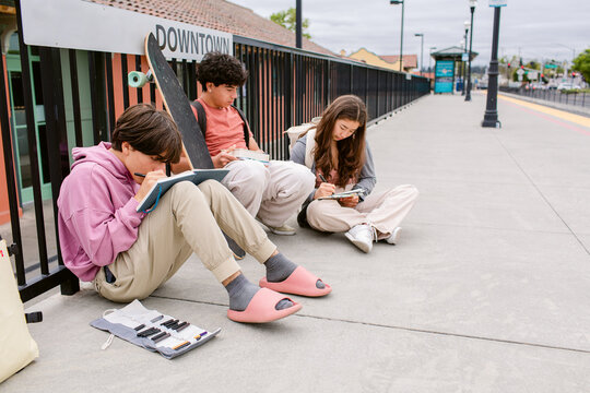 Teen studens waiting for the train at station