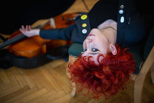 Ginger beautiful woman with Cello musical instrument