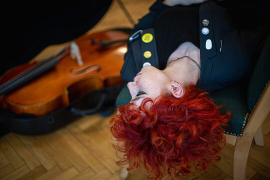 Ginger beautiful woman with Cello musical instrument