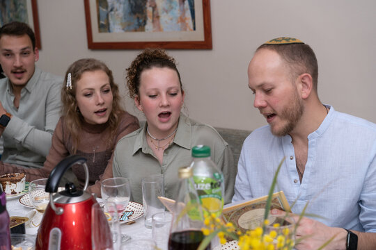 Four Siblings Celebrate Passover, Reading Haggadah, Singing Songs.