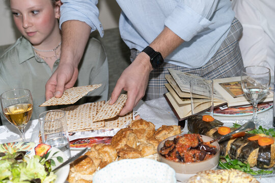 Tradition and Togetherness. Man Breaking Matzah on Passover