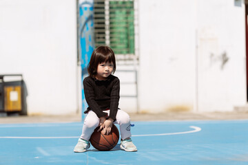little girl playing basketball
