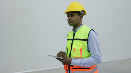 portrait young asian male worker using digital tablet to check warehouse shelves in warehouse