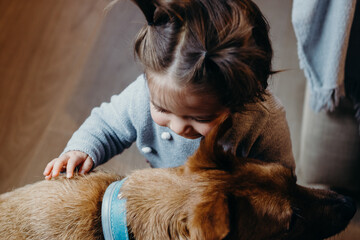 Cute baby girl Hugging Dog