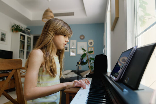 A girl playing the piano at home
