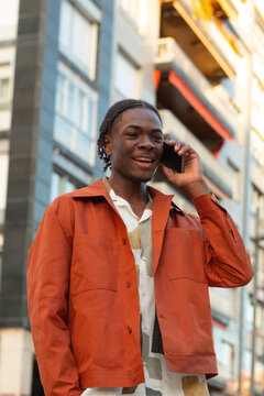 Cheerful black male talking on the phone