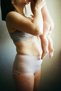 Mother rising and kissing her child