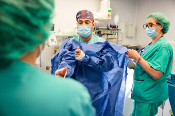 Confident surgeons preparing for surgery