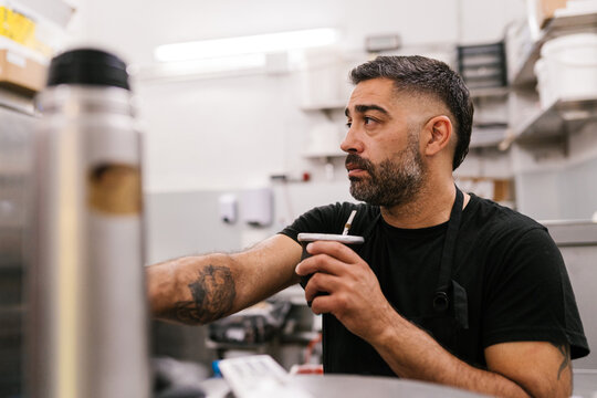 Employee drinking mate in a butcher's shop